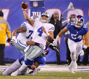 Dallas Cowboys quarterback Dak Prescott (4) gets a pass away under intense pressure from New York Giants defensive end Romeo Okwara (78) late in the fourth quarter during the Dallas Cowboys vs. the New York Giants NFL football game at MetLife Stadium in East Rutherford, New Jersey on Sunday, December 11, 2016. (Louis DeLuca/The Dallas Morning News)