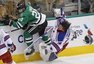 Dallas Stars center Cody Eakin (20) hits New York Rangers goalie Henrik Lundqvist (30) and knocks him out of the game for a major penalty in the first period at American Airlines Center in Dallas on December 15, 2016. (Nathan Hunsinger/The Dallas Morning News)