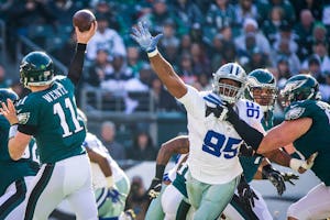 Philadelphia Eagles quarterback Carson Wentz (11) throws a pass under pressure fro Dallas Cowboys defensive end David Irving (95) during the first half of an NFL football game at Lincoln Financial Field on Sunday, Jan. 1, 2017, in Philadelphia. (Smiley N. Pool/The Dallas Morning News)