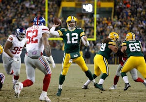 Green Bay Packers quarterback Aaron Rodgers (12) throws a touchdown pass during the first half of an NFC wild-card NFL football game against the New York Giants, Sunday, Jan. 8, 2017, in Green Bay, Wis. (AP Photo/Mike Roemer)