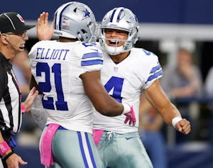 Dallas Cowboys quarterback Dak Prescott (4) congratulates Dallas Cowboys running back Ezekiel Elliott (21) on a 60 yard rushing touchdown during the second half of play at AT&T Stadium in Arlington on Sunday, October 9, 2016. The Dallas Cowboys defeated the Cincinnati Bengals 28-14. (Vernon Bryant/The Dallas Morning News)