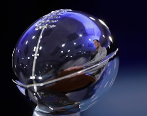 New England Patriots quarterback Tom Brady is reflected in the Lombardi Trophy during a news conference after the NFL Super Bowl 51 football game Monday, Feb. 6, 2017, in Houston. (AP Photo/David J. Phillip)