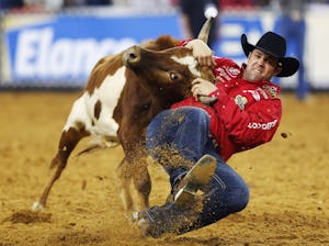 Bray Armes of Pilot Point competes in the steer wrestling event of The American at AT&T Stadium in Arlington on Sunday, February 19, 2017. (Vernon Bryant/The Dallas Morning News)