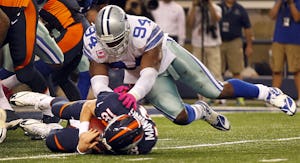 Dallas Cowboys defensive end DeMarcus Ware (94) pounces on Denver Broncos quarterback Peyton Manning (18) after dropping to the ground on the next to last play of the game at AT&T Stadium in Arlington, Sunday, October 6, 2013. The Cowboys lost on a last second field goal to Denver 51-48. (Tom Fox/The Dallas Morning News)