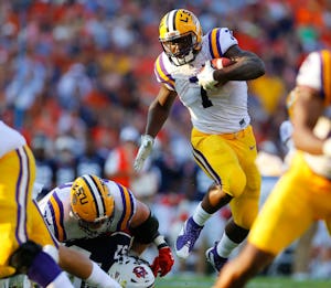 FILE - In this Sept. 24, 2016, file photo, LSU running back Leonard Fournette (7) hurdles an Auburn player as he carries the ball during the first half of an NCAA college football game, in Auburn, Ala. (AP Photo/Butch Dill, File)