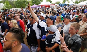 Dallas Cowboys fans Chris Scroggins and his son, Mason Scroggins, 2, both from Ennis, Texas wait for Cowboys quarterback Dak Prescott's appearance at Mudbug Bash 2017, at the Levitt Pavilion in Arlington Saturday April 15, 2017. The promotional event was held for fans of  105.3 The Fan radio station. (Ron Baselice/The Dallas Morning News)