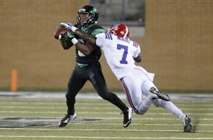 North Texas Mean Green wide receiver Carlos Harris (9) catches a pass in front of Louisiana Tech Bulldogs defensive back Xavier Woods (7) in the third quarter during the Louisiana Tech University Bulldogs vs. the University of North Texas Mean Green NCAA football game at Apogee Stadium in Denton on Thursday, September 11, 2014. (Louis DeLuca/The Dallas Morning News