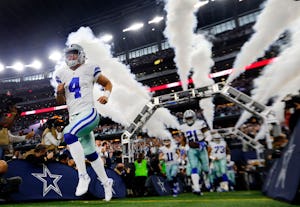 Dallas Cowboys quarterback Dak Prescott (4) races onto the field followed by Ezekiel Ellitott (21) during player introductions before facing the Green Bay Packers in their NFC Divisional playoff game at AT&T Stadium in Arlington, Texas, Sunday, January 15, 2017. (Tom Fox/The Dallas Morning News)