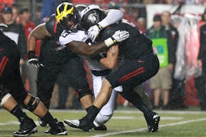 PISCATAWAY, NJ - OCTOBER 08: Taco Charlton #33 of the Michigan Wolverines sacks Chris Laviano #5 of the Rutgers Scarlet Knights during the first half at High Point Solutions Stadium on October 8, 2016 in Piscataway, New Jersey. (Photo by Michael Reaves/Getty Images)