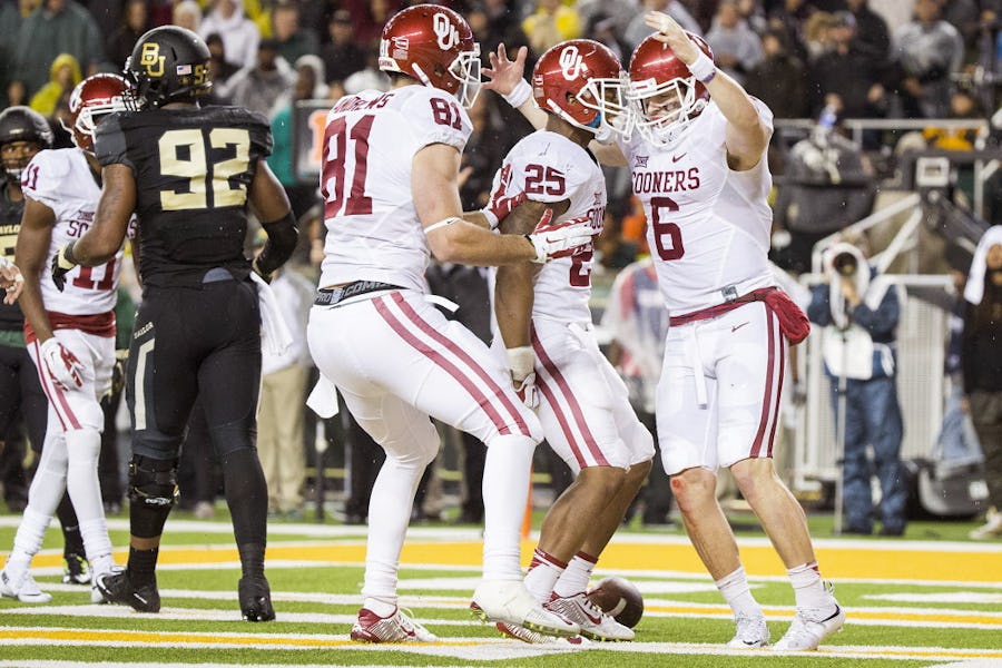 Oklahoma Sooners quarterback Baker Mayfield (6) celebrates with running back Joe Mixon (25) and tight end Mark Andrews (81) after scoring on 2-yard touchdown run during the first half of an NCAA football game against Baylor at McLane Stadium on Saturday, Nov. 14, 2015, in Waco, Texas. (Smiley N. Pool/The Dallas Morning News)