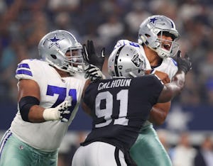 ARLINGTON, TX - AUGUST 26: La'el Collins #71 of the Dallas Cowboys tries to protect Dak Prescott #4 of the Dallas Cowboys as he is hit by Shilique Calhoun #91 of the Oakland Raiders in the second quarter of a preseason game at AT&T Stadium on August 26, 2017 in Arlington, Texas. (Photo by Tom Pennington/Getty Images)