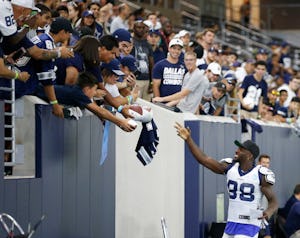 Dallas Cowboys wide receiver Dez Bryant (88) waves at a fan after getting a note from a kid prior to the start of practice during training camp at The Star in Frisco on Tuesday, August 22, 2017. (Vernon Bryant/The Dallas Morning News)
