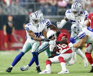 Dallas Cowboys free safety Byron Jones (31), Dallas Cowboys safety Xavier Woods (25), Dallas Cowboys outside linebacker Jaylon Smith (54), and Dallas Cowboys defensive tackle Brian Price (92) tackle Arizona Cardinals running back Andre Ellington (38) during the first half of play at University of Phoenix Stadium in Glendale, Arizona on Monday, September 25, 2017. (Vernon Bryant/The Dallas Morning News)