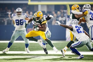 Green Bay Packers running back Aaron Jones (33) gets past Dallas Cowboys linebacker Jaylon Smith (54) during the second half of an NFL football game at AT&T Stadium on Sunday, Oct. 8, 2017, in Arlington. The Packers won the game 35-31.