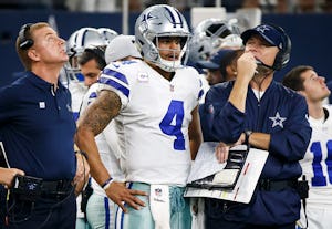 Dallas Cowboys head coach Jason Garrett, quarterback Dak Prescott (4), and offensive coordinator Scott Linehan wait for a replay review of fourth-and-one play a during the second half of an NFL football game against the Green Bay Packers at AT&T Stadium on Sunday, Oct. 8, 2017, in Arlington, Texas. The Packers won the game 35-31. (Smiley N. Pool/The Dallas Morning News)