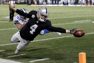 Oakland Raiders quarterback Derek Carr (4) fumbles the ball into the end zone after getting shoved by Dallas Cowboys safety Jeff Heath (38) during the fourth quarter of a game in Oakland, Calif., on Sunday, Dec. 17, 2017. (AP Photo/Ben Margot)