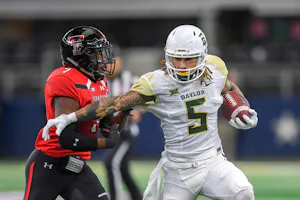 LUBBOCK, TX - NOVEMBER 24: Wide receiver Jalen Hurd #5 of the Baylor Bears tries to get past defensive back Jah'Shawn Johnson #7 of the Texas Tech Red Raiders during the first half of the game on November 24, 2018 at AT&T Stadium in Arlington, Texas. (Photo by John Weast/Getty Images) ORG XMIT: 775238884