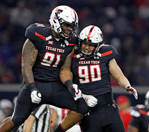 Texas Tech's Nelson Mbanasor (91) and Quentin Yontz (90) celebrate after breaking up a play during an NCAA college football spring game, Saturday, April 13, 2019, in Frisco, Texas. (Brad Tollefson/Lubbock Avalanche-Journal via AP)