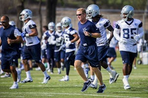 Dallas Cowboys head coach Jason Garrett runs with his team between drills during the first practice of training camp on Thursday, July 30, 2015, in Oxnard, Calif. (Smiley N. Pool/The Dallas Morning News)